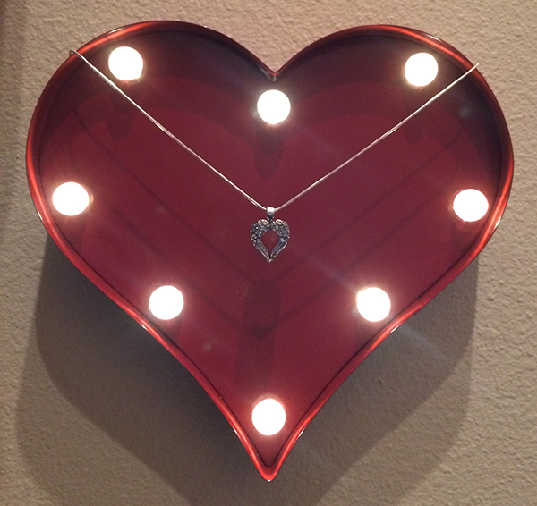 cremation jewelry displayed on artwork